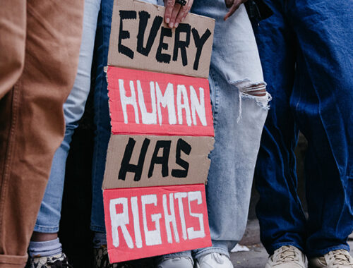 Group of people holding a sign 