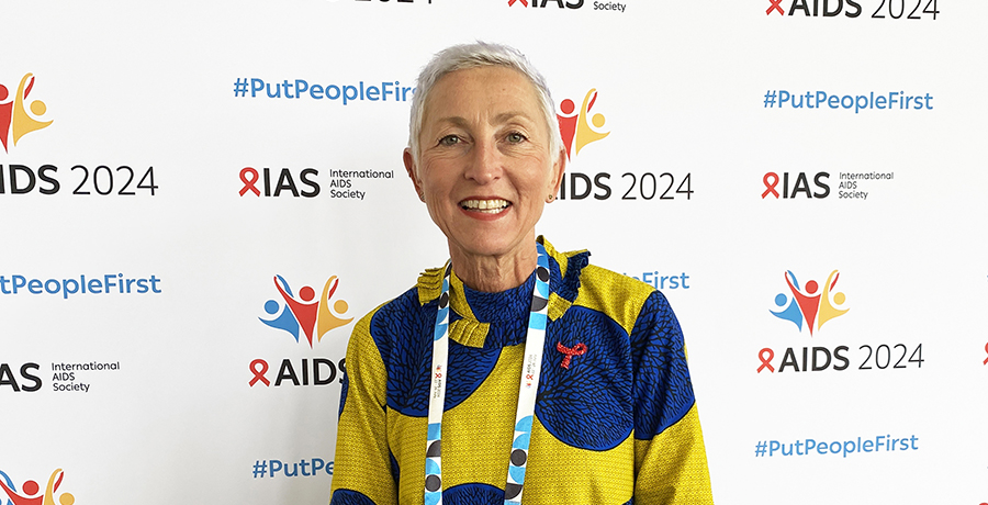 Dr. Linda-Gail Bekker, standing in front of the AIDS 2024 step and repeat 